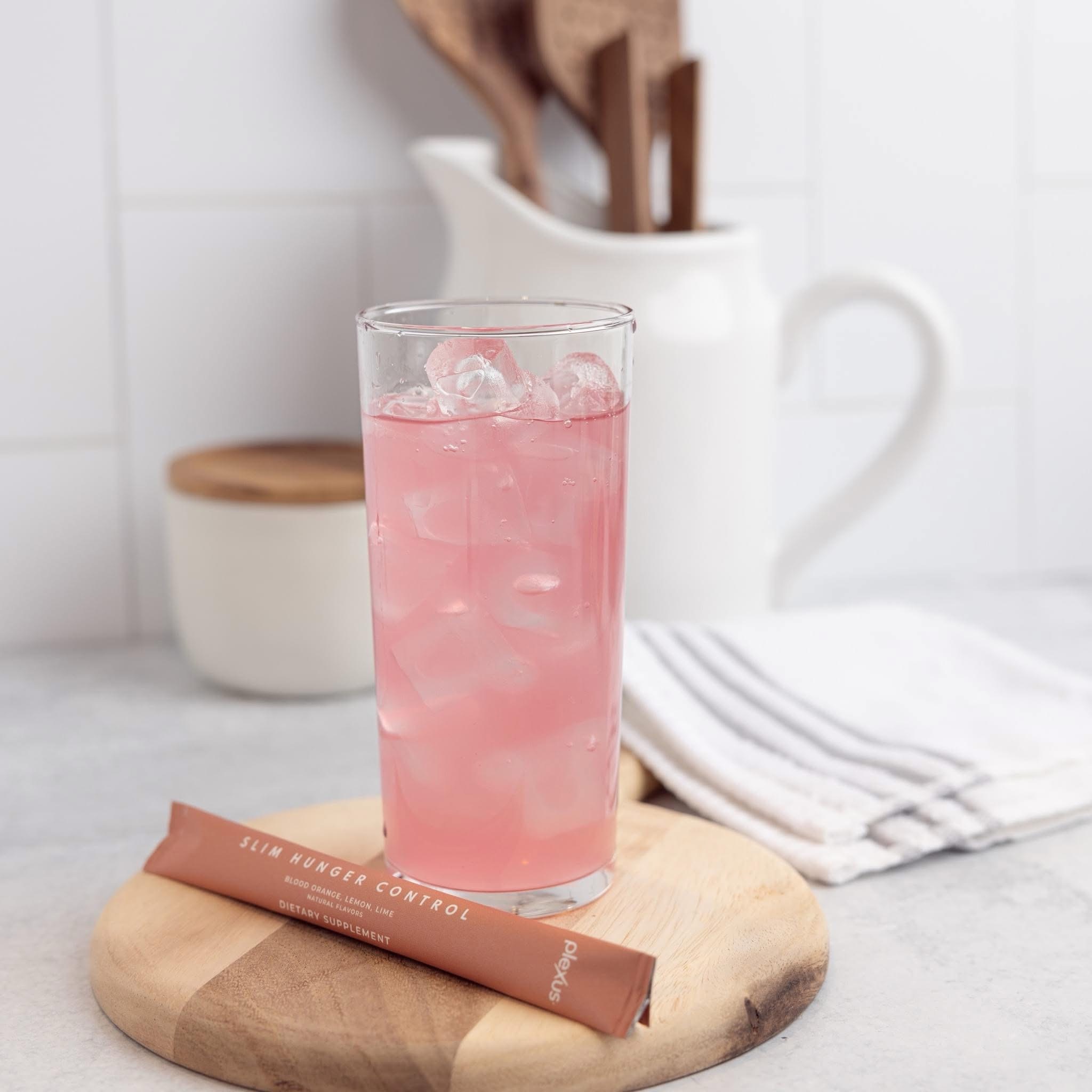 A chilled pink wellness drink in a bright, welcoming kitchen